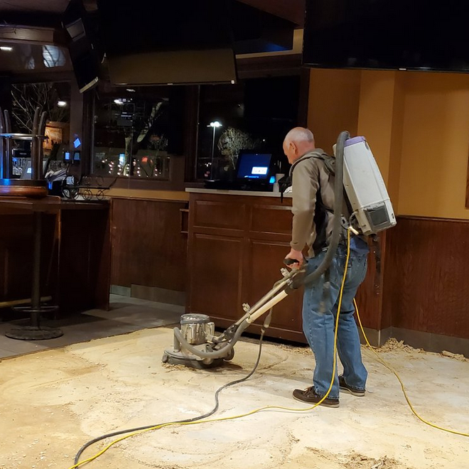Alpine technician sanding a floor